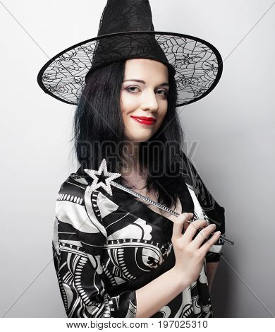 Funny Witch. Young happy woman with canival hat. Studio shot.