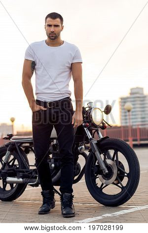 Brutal Man Near His Cafe Racer Custom Motorbike.
