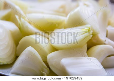 Close up pieces of chopped raw onion ready for cooking