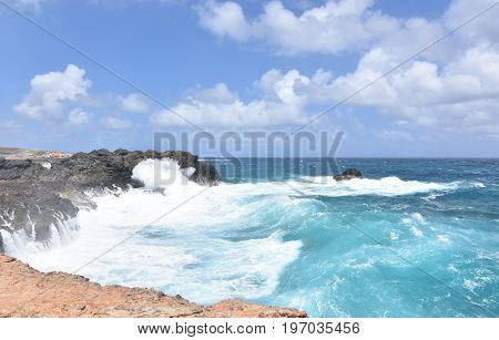 Waves smashing against the rocks on Andicuri Beach in Aruba.
