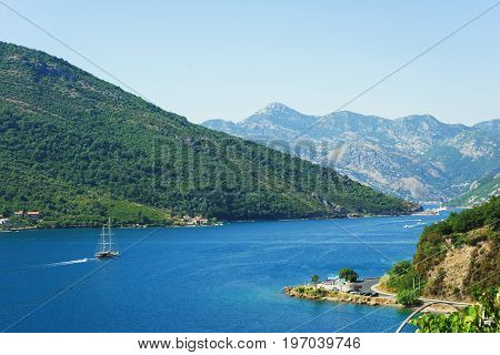 View of Boko Kotorska bay in Montenegro on a hot summer day. Vacation on the beach, the morning landscape in the bay. The southernmost fjord of Europe.