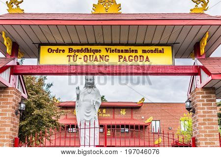 Montreal Canada - May 26 2017: Buddhist Temple entrance and Tu Quang Pagoda sign in city in Quebec region during wet rain on cloudy day