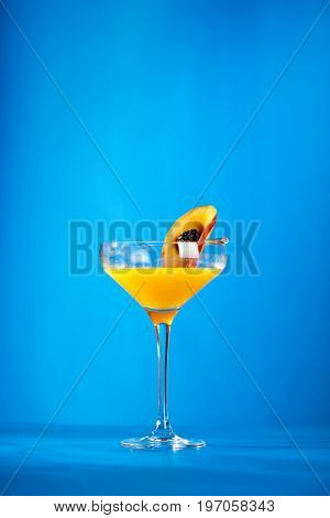 Summer  Cocktail -  Pornstar Martini. Drink with Passion fruit, Vodka, Liquor, Vanilla Syrup, Champagne and Lime Juice. Tropical Leaf on Background