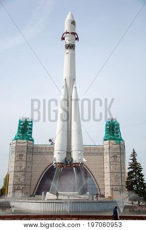 Moscow - May 5 2017: the front view of the model of the Vostok spacecraft with artificial pond on the foreground and pavilion under restoration on the background. VDNKh