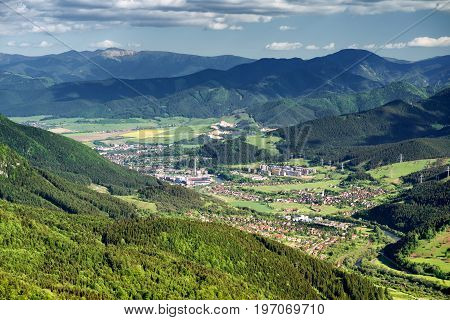 City Ruzomberok from hill Hrdos (Ostre) in Mala Fatra national park in Slovakia. Low Tatras mountains at backround