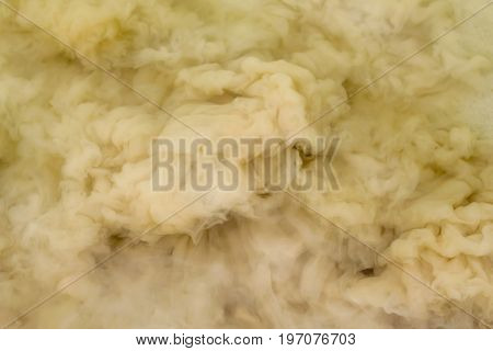 Splash of yellow sand in water abstract background