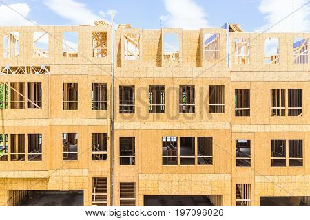 Fairfax, Usa - January 20, 2017: Construction Workers Building New Modern Townhouses With Garages On