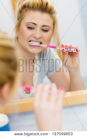 Woman Brushing Cleaning Teeth In Bathroom