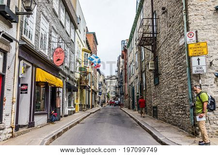 Quebec City, Canada - May 29, 2017: Old Town Alley Street With Shops And Stores With Stone Wall Buil
