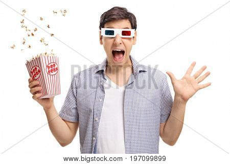 Terrified guy with a pair of 3D glasses and popcorn isolated on white background