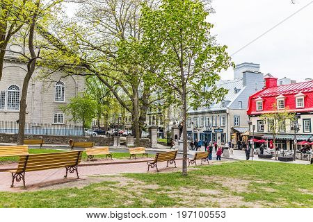 Quebec City Canada - May 29 2017: Old town Sainte Anne street with restaurants by place d'arms park by Chateau Frontenac with people walking