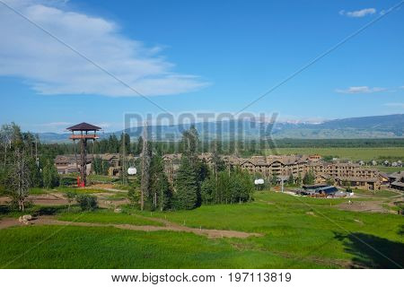 JACKSON HOLE, WYOMING - JUNE 27, 2017: Teton Village seen from the Bridger Gondola. The Gondola takes hikers and sightseers to the summit of Rendezvous Mountain for views of the valley.