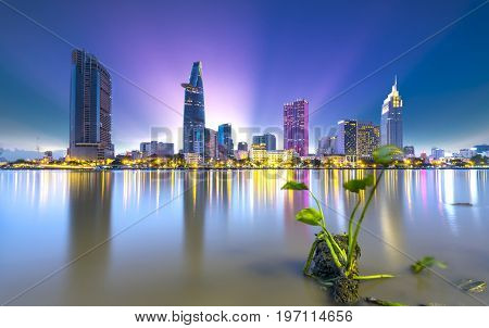 Ho Chi Minh City, Vietnam - July 9, 2017: Riverside City sunset end of day brighter sparkling skyscrapers coal along river, this is a symbol economic development country in Ho Chi Minh City, Vietnam
