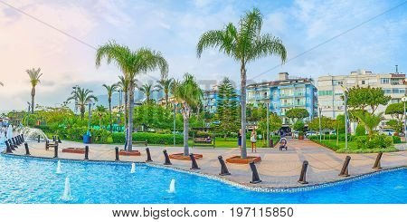 ALANYA TURKEY - MAY 8 2017: Panorama of Abdurrahman Alaettinoglu park decorated with fountain tall palms and scenic flower beds the perfect place for relax after cisiting of Kleopatra beach on May 8 in Turkey.