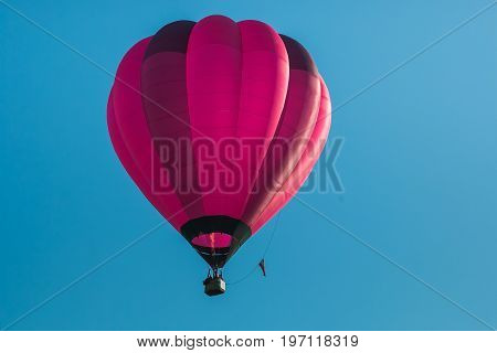 Pink hot air balloon in the blue sky