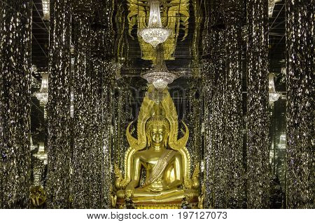 The golden buddha statue in the famous temple in Thailand.