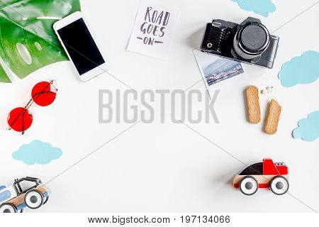 planing trip with child with mobile and camera on white background top view space for text