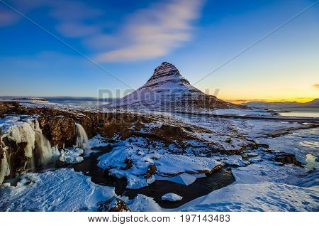 Kirkjufellsfoss Waterfall with Kirkjufell mountain at sunrise Iceland