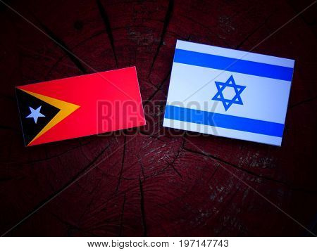 East Timorese Flag With Israeli Flag On A Tree Stump Isolated