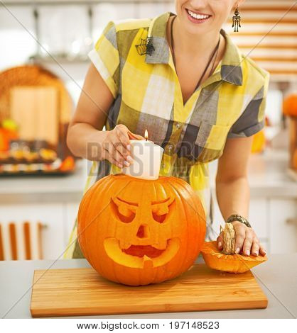 Housewife Putting Candle Inside Orange Pumpkin Jack-o-lantern