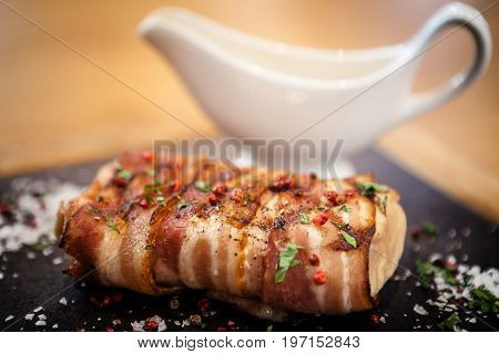 Rack of pork. Wrapped in bacon. Served with pepper sauce.