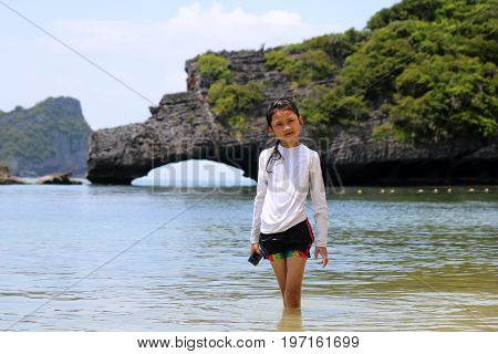 Asian girls enjoy on the beach in Thailand.