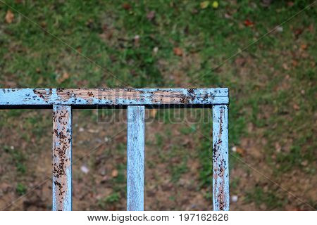 Termites are rotting banister wood on the balcony in local wooden house.