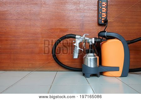 Electric sprayer with wooden wall for industry.