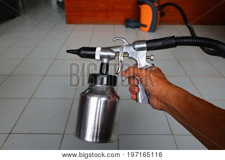 Electric sprayer with wooden wall for industry.