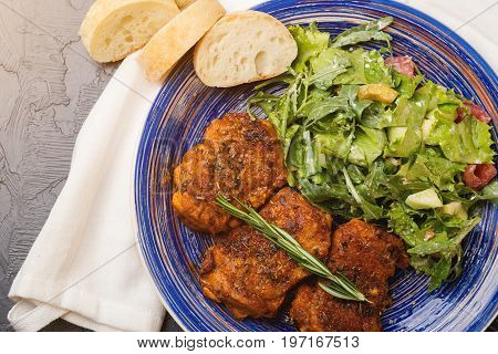 Platter Of Chicken Thighs Piri Piri Coated In Hot Sauce With Salad.