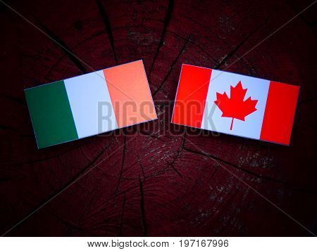 Irish Flag With Canadian Flag On A Tree Stump Isolated