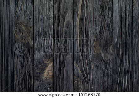 Black Wood Texture for Background. Vertically oriented wooden slats with a clear relief pattern of wood texture