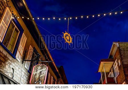 Quebec City Canada - May 31 2017: Lower old town street Rue du Petit Champlain with hanging decorations by restaurant