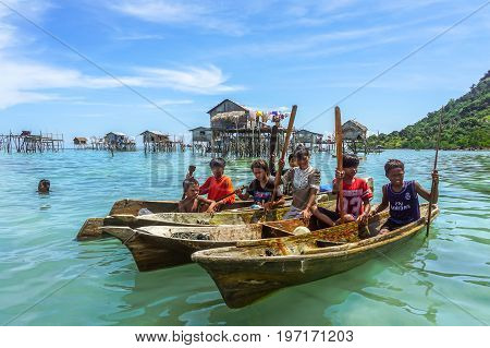Semporna,Sabah,Malaysia-Apr 23,2017:Sea Gypsy kids on unique handmade boats surrounded by beautiful clear water of the Bodgaya island,Semporna,Sabah,Malaysia.