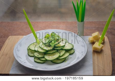Fresh cucumber salad on a flat porcelain plate