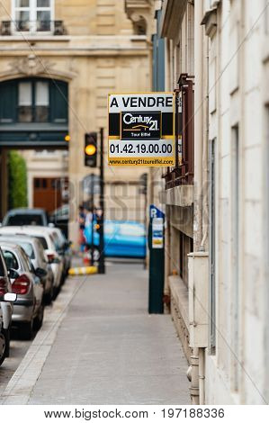 PARIS FRANCE - MAY 21 2016: Century 21 for sale a vendre signage on the corner of a building in Paris France. Century 21 Real Estate LLC is an American real estate agent franchise company founded in 1971