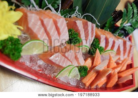 Crab stick and salmon sushi japanese raw fish sashimi set served with crab stick (Kanikama) on ice dish