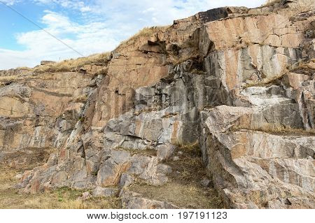 Granite and basalt rock formations against the background of a deep blue sky