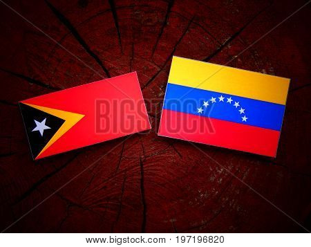 East Timorese Flag With Venezuelan Flag On A Tree Stump Isolated
