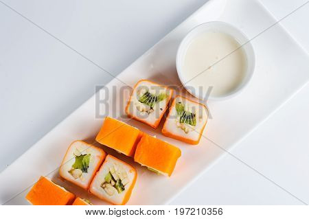 Dessert Maki Sushi - Roll With Various Fruit In Rice Pudding And Coconut Flakes