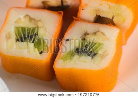 Dessert Maki Sushi - Roll With Various Fruit In Rice Pudding And Coconut Flakes