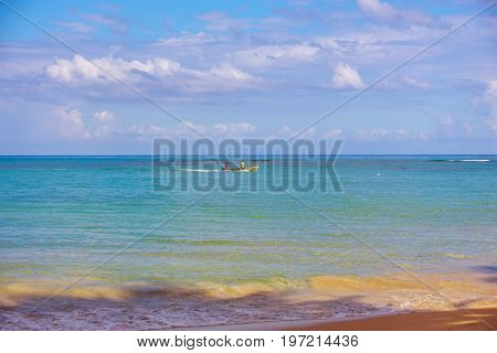Fairy seascape. Boat with two men in the blue sea.