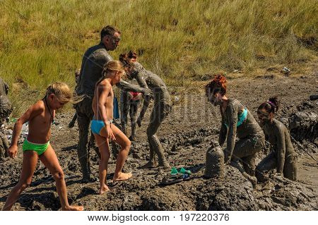 Kuchugury, Russia - July 16, 2017: Azov scorching heat mud volcano. People take procedures with healing mud