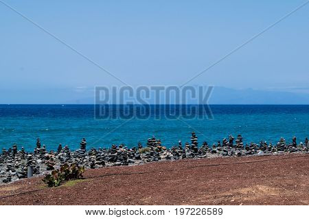 Cairn rock pebbles on Tenerife beach at Costa Adeje, Adeje, Tenerife Canary Islands, Spain