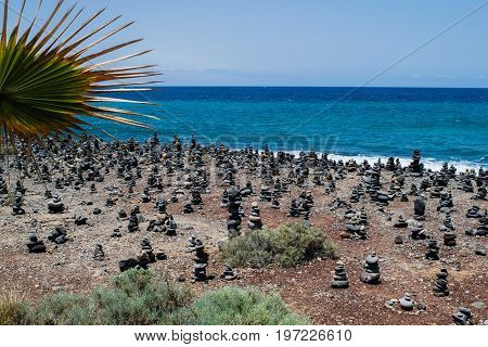 Cairn rock pebbles on Tenerife beach at Costa Adeje, Adeje, Tenerife Canary Islands, Spain