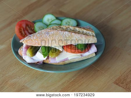 Fresh Home Made Sandwich With Ham, Bacon, Cheese Tomato And Pickles And Basil Leaves
