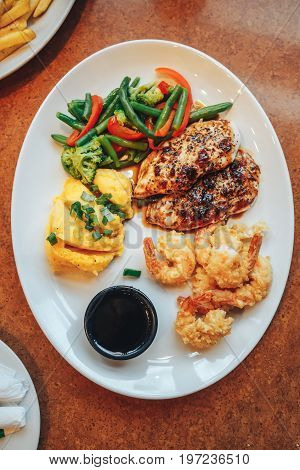 Roasted chicken breast and mashed potatoes and shrimp breaded
