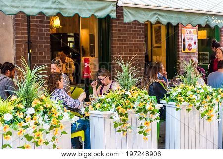 Montreal, Canada - May 27, 2017: Old Town Area With People Sitting And Eating By Street In Evening O