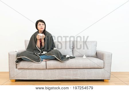Female Teenger Catching A Cold Sitting On Sofa