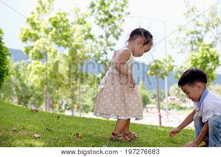 Happy child blowing soap bubbles in spring park with lens flares